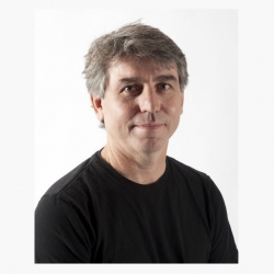 Professional headshot of Joseph Peragine in black shirt set against white backdrop