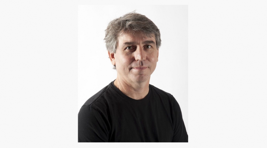 Professional headshot of Joseph Peragine in black shirt set against white backdrop